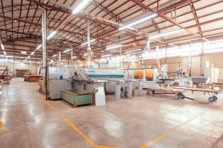 Electric Vehicle Battery Recycling Companies Attract Major Automaker Partnerships Industrial recycling facility with machinery processing materials