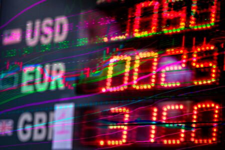 Multiple international currencies and exchange rate displays showing global financial markets