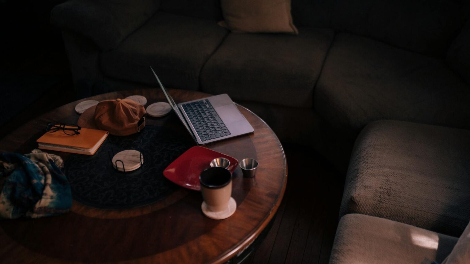 Gig Economy Workers Drive Surge in Health Savings Account Adoption Freelancer working on laptop at coffee table representing independent gig work lifestyle