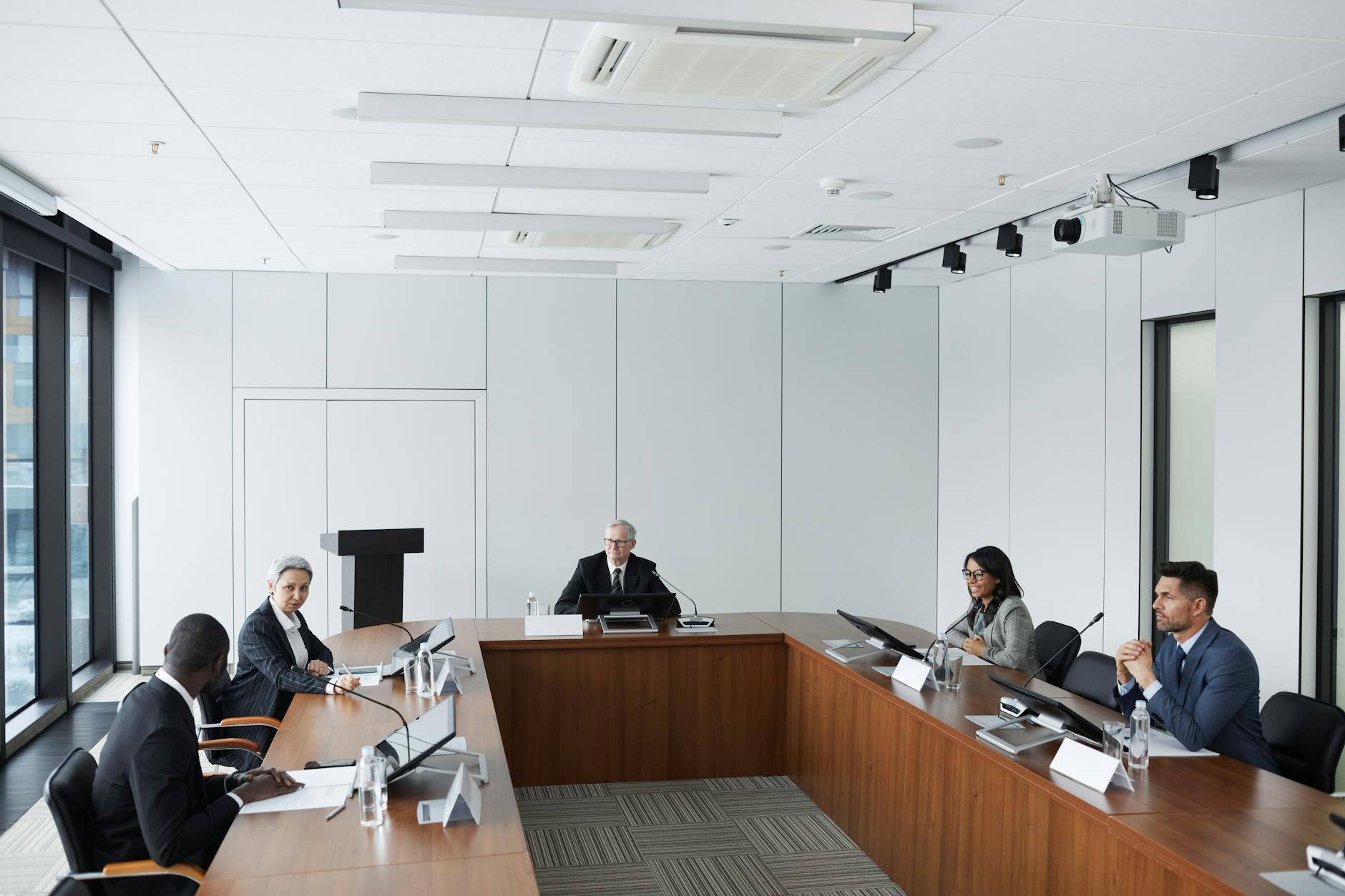Professional business meeting with financial documents and charts on conference table