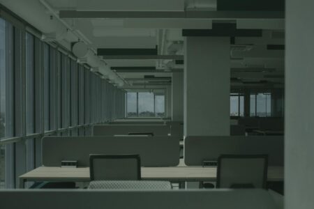 Vacant office building with dark windows showing declining commercial real estate occupancy