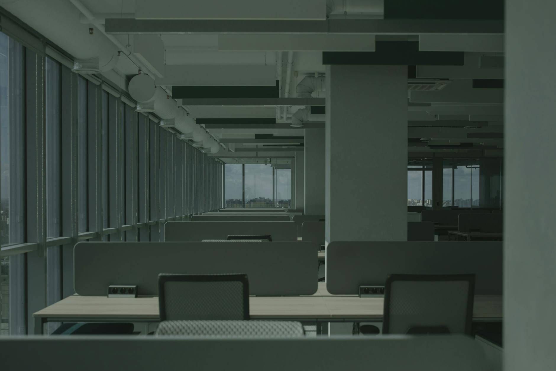 Vacant office building with dark windows showing declining commercial real estate occupancy
