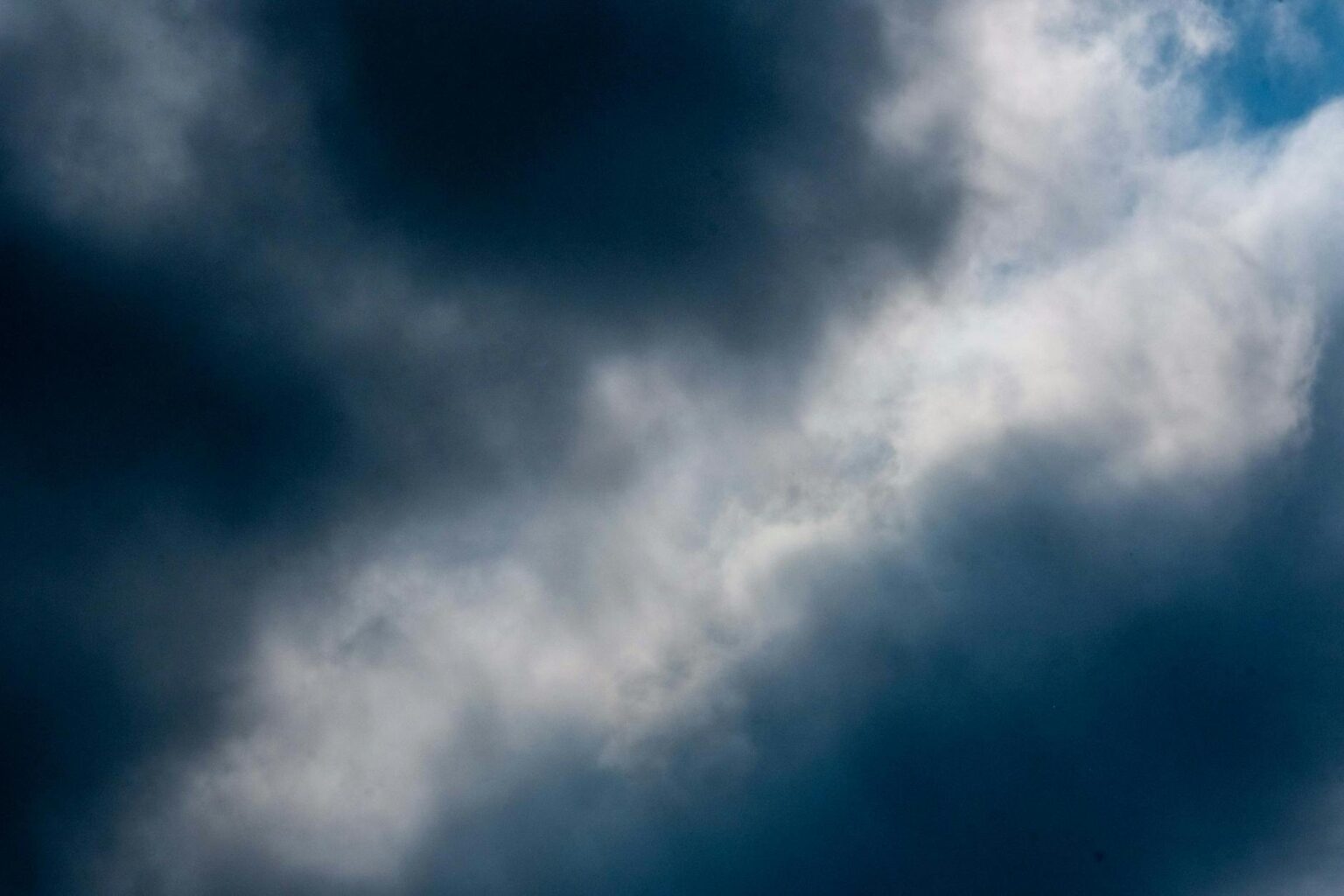 Insurance Companies Pivot to Climate Risk Assessment as Weather Patterns Shift Dark storm clouds gathering over landscape showing changing weather patterns