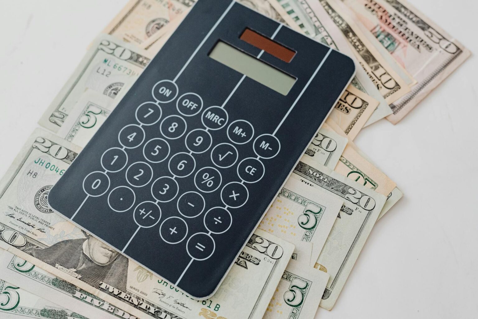 Why High-Yield Savings Accounts Are Outperforming Bond Funds Financial calculator with money and investment documents showing rate comparisons