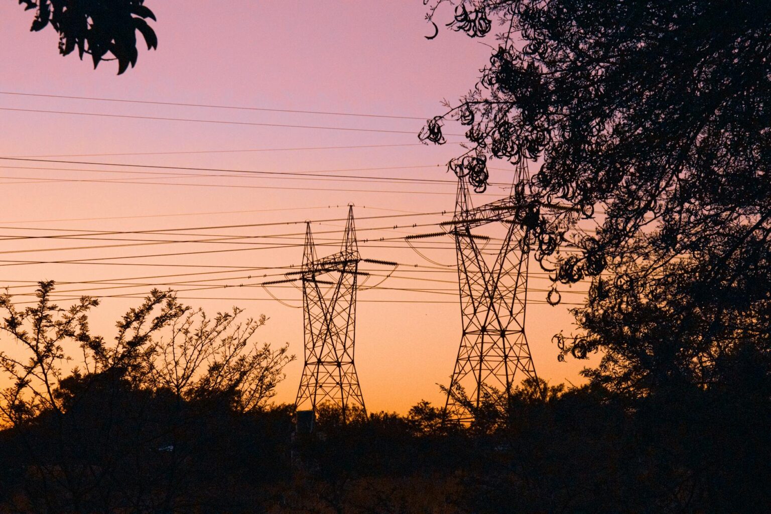 Why Financial Advisors Are Recommending Utility Stock Diversification Strategies Electrical transmission lines silhouetted against sunset sky