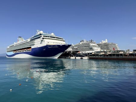 Major Cruise Lines Expand Mediterranean Routes as European Tourism Recovers Large cruise ship sailing in Mediterranean waters with coastal mountains in background