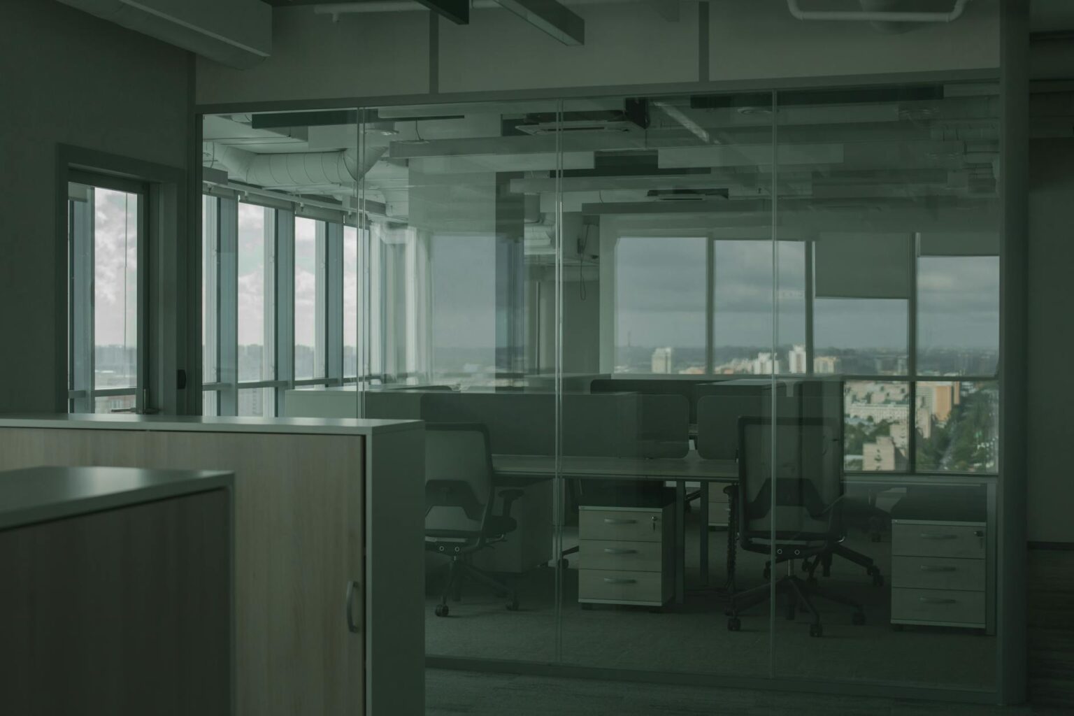 Remote Work Policies Drive Office-to-Residential Conversion Boom Empty office building interior with vacant cubicles and large windows