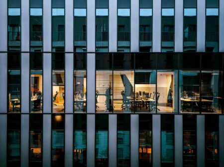 Modern commercial office building exterior showing glass facade and urban architecture