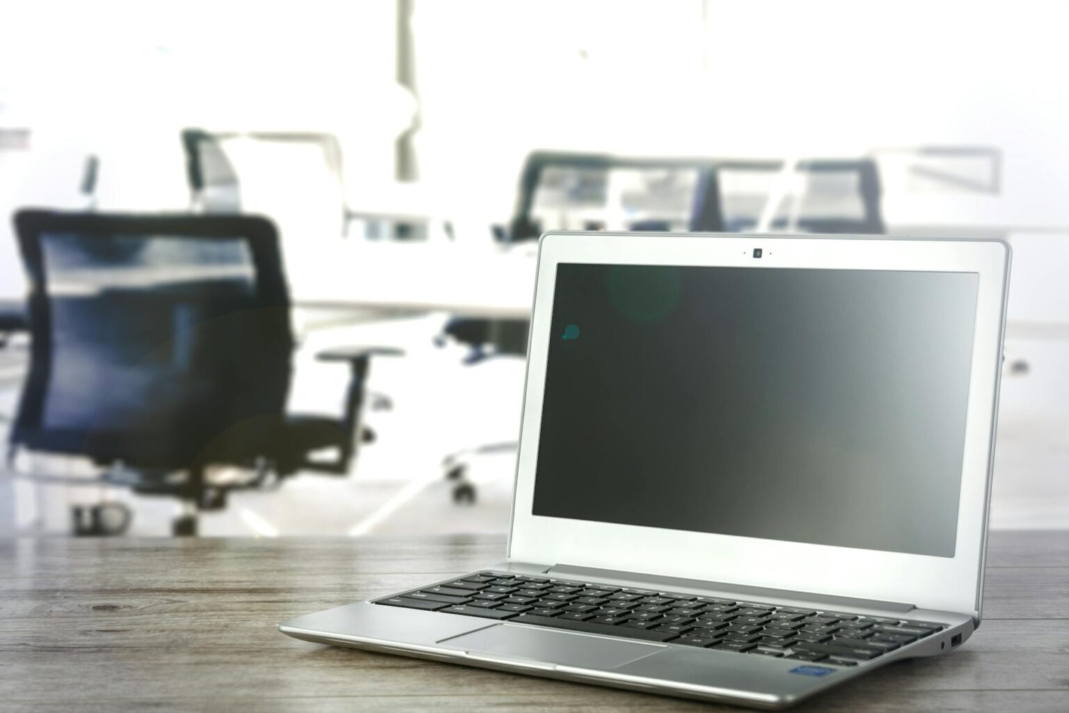 Modern office workspace with multiple computer screens displaying social media content moderation interfaces