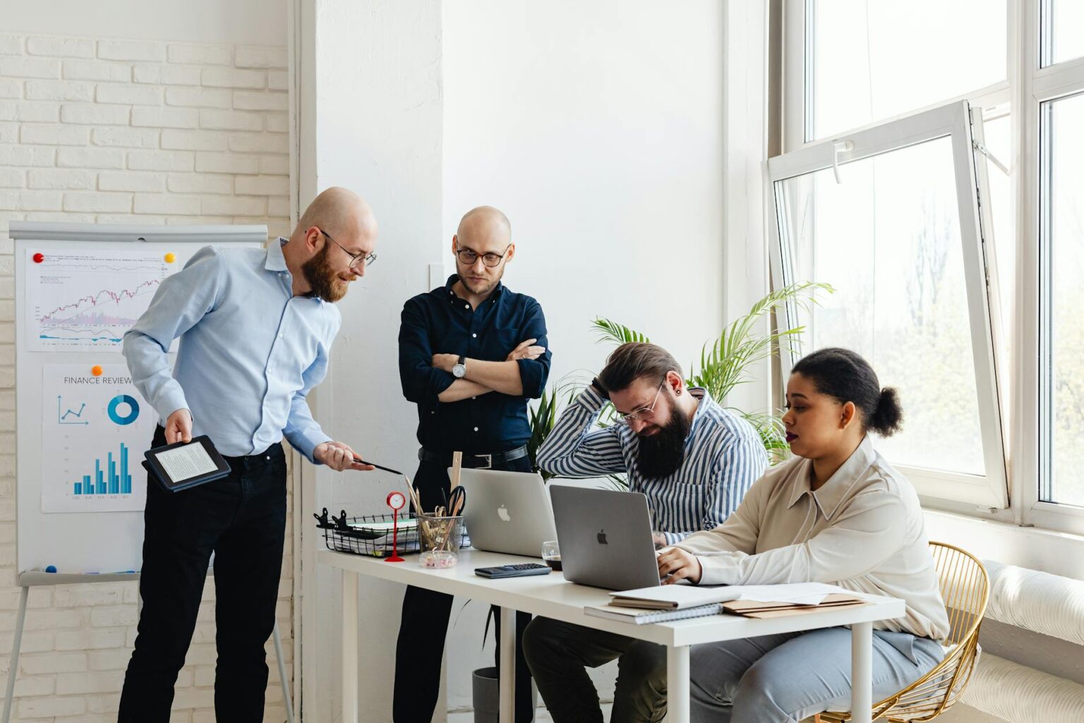 Business professionals in modern conference room discussing financial documents