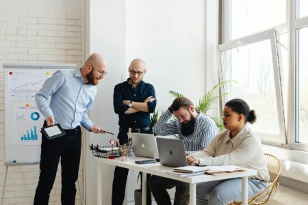 Business professionals in modern conference room discussing financial documents