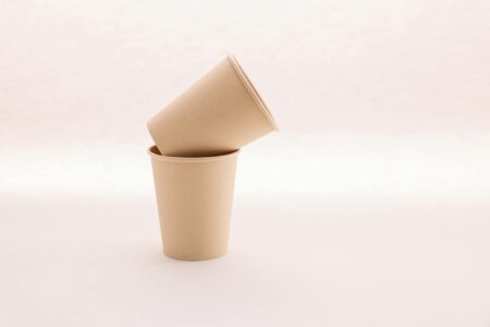 Pile of disposable coffee cups showing environmental waste problem