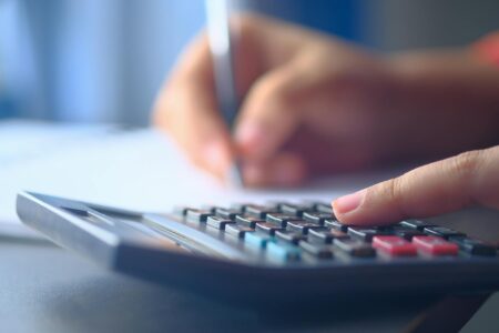 Financial calculator and documents showing Treasury bill ladder investment planning