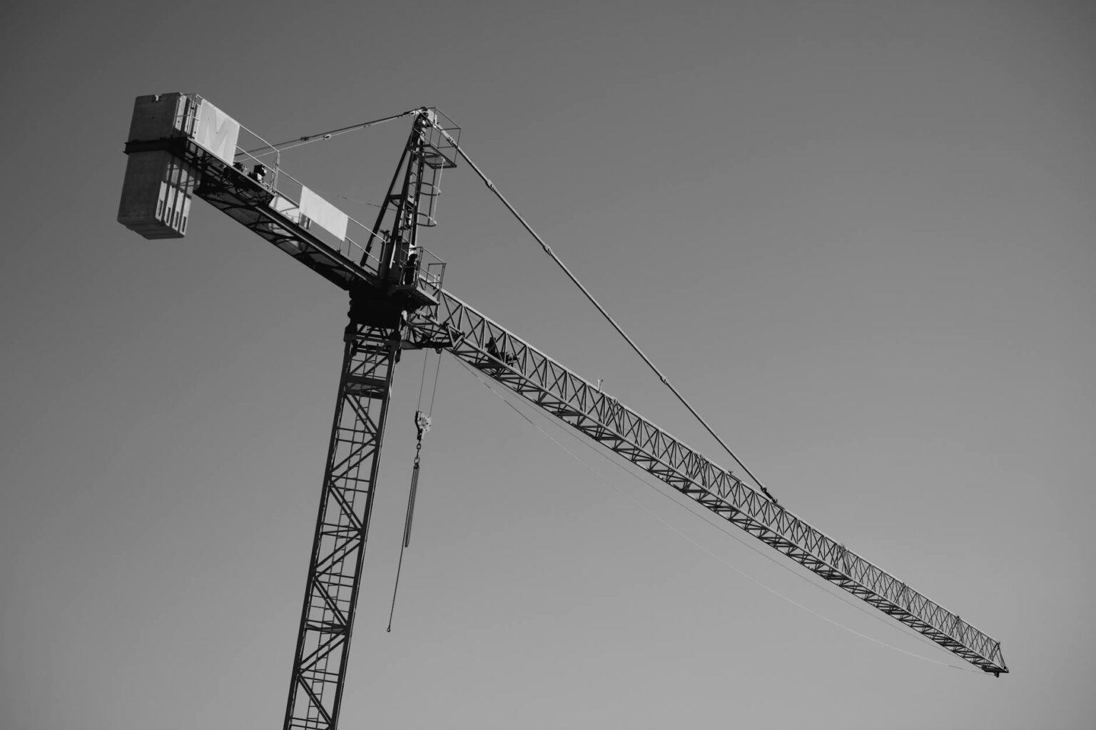 How Target-Date Fund Allocations Are Shifting Toward Infrastructure Assets Construction crane against blue sky representing infrastructure development and investment