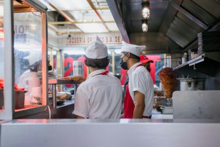 Fast Casual Restaurant Chains Embrace Ghost Kitchen Expansion Models Professional commercial kitchen with stainless steel equipment and prep stations for restaurant operations