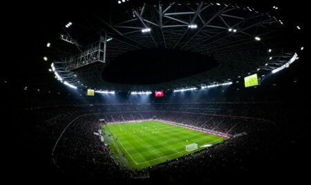 Illuminated stadium lights at sports venue during evening event
