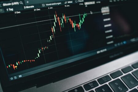 Modern trading floor with multiple computer screens displaying financial data and market charts