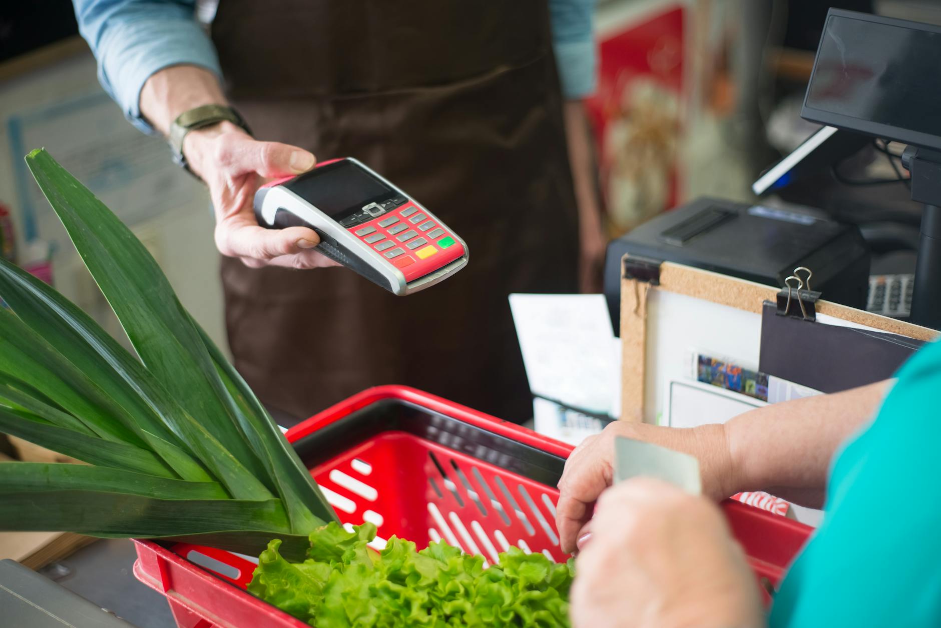 Modern grocery store checkout area with self-service kiosks and traditional cashier lanes