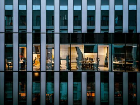 Modern glass office building representing commercial real estate investment trust properties