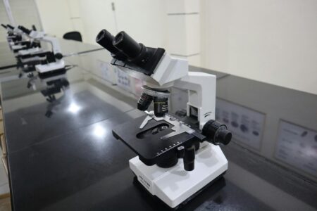 Scientific laboratory equipment with microscope for biotech research and drug development