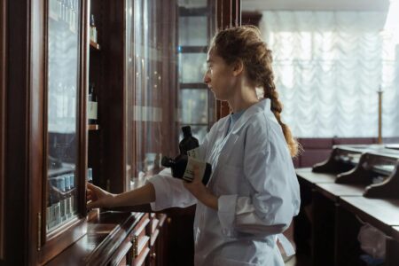Interior view of a pharmacy with prescription counter and shelving for medications