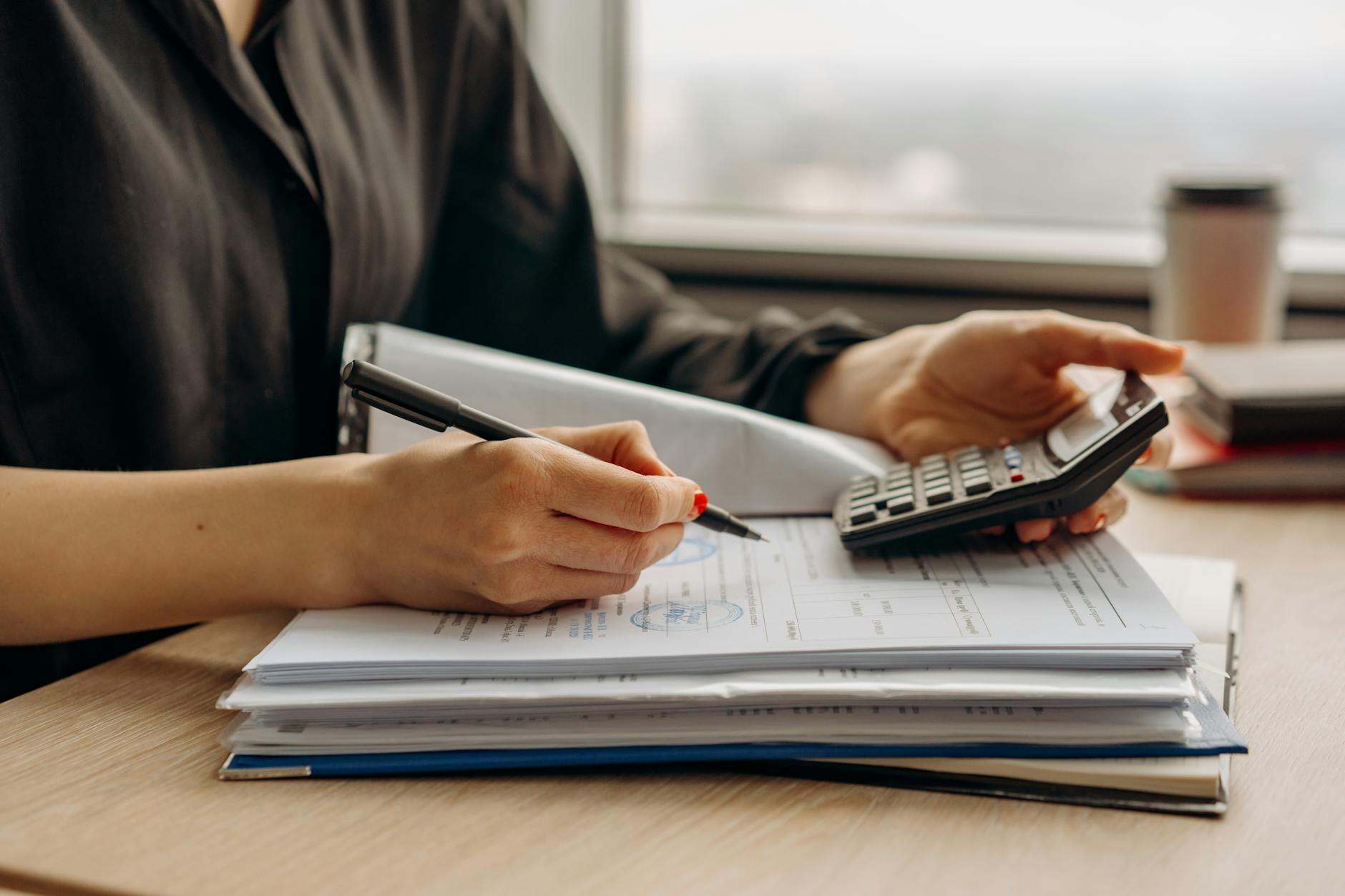 Financial planning documents and calculator on desk for investment analysis