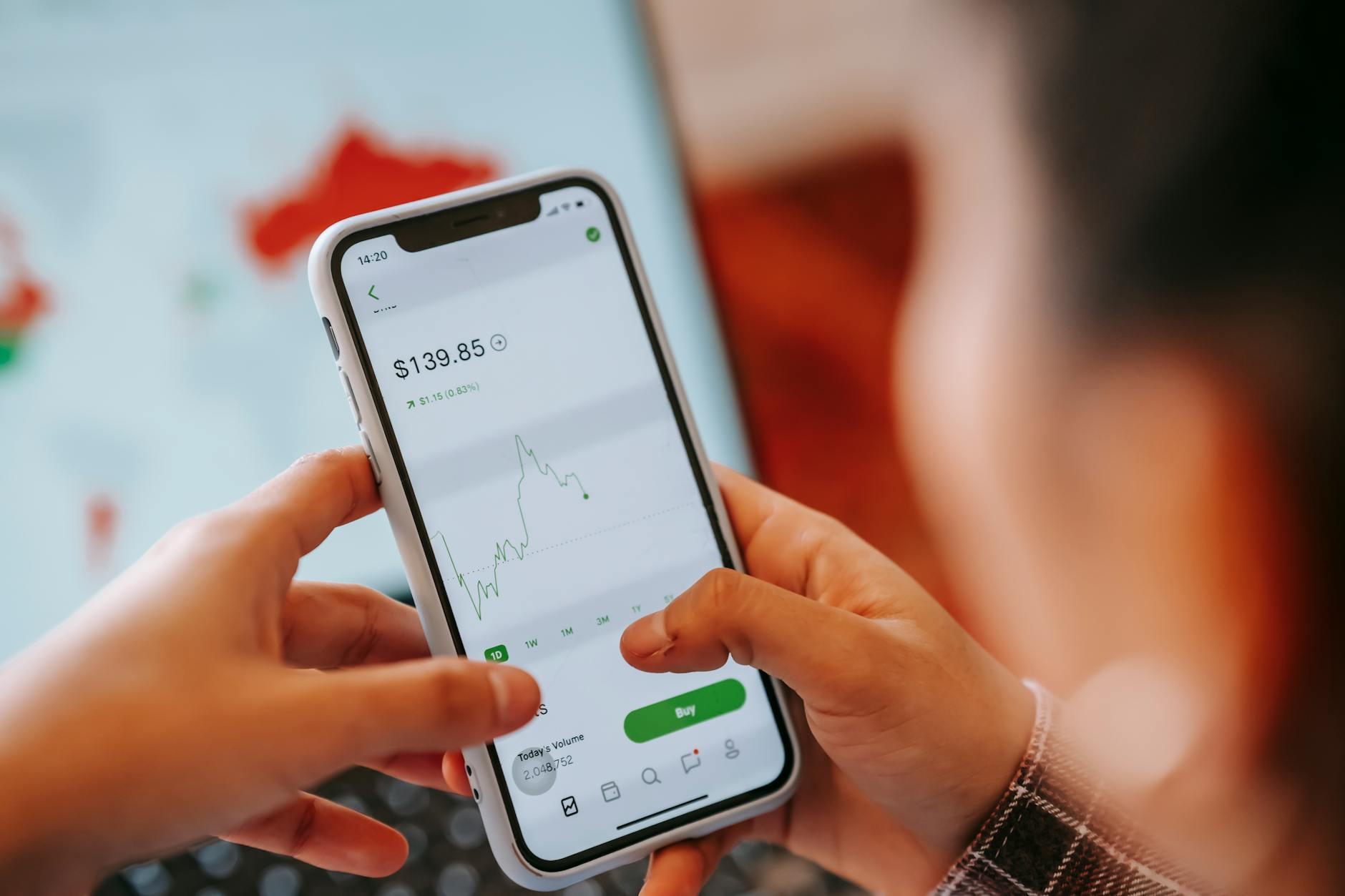 Smartphone displaying stock trading application with market data and portfolio information