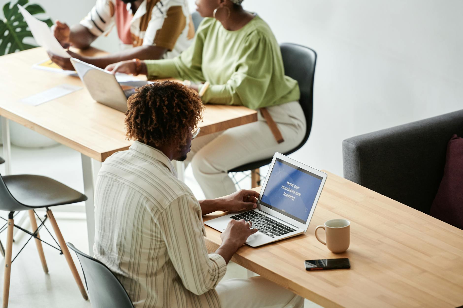 Professional coworking space with desks, chairs, and business people working