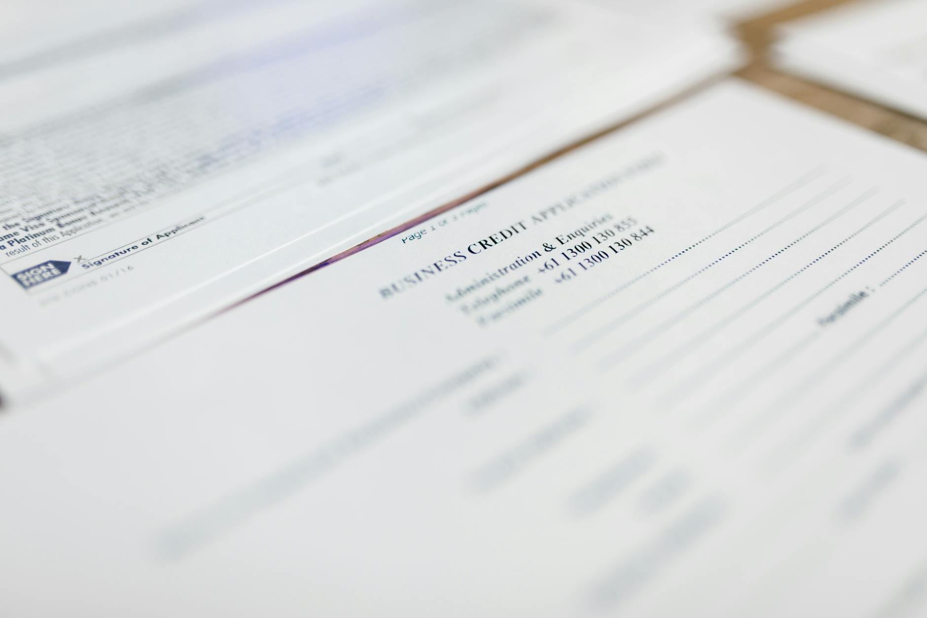 Tax forms and business documents spread across office desk with calculator