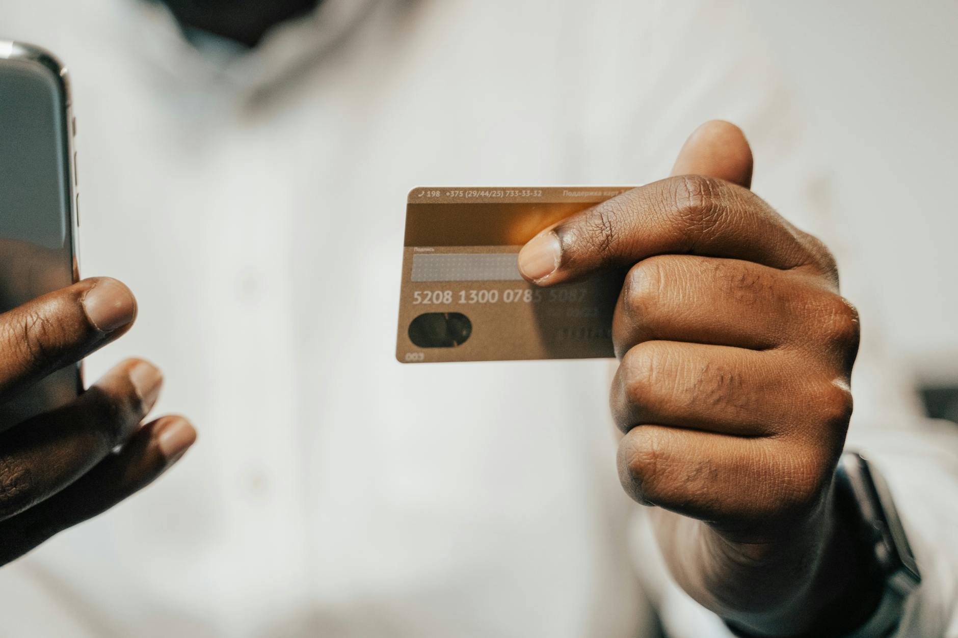 Person using smartphone mobile banking app to manage high-yield savings account