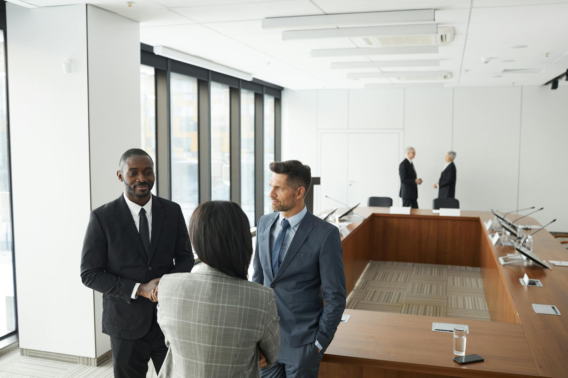Corporate executives reviewing financial documents and dividend payout strategies in modern conference room