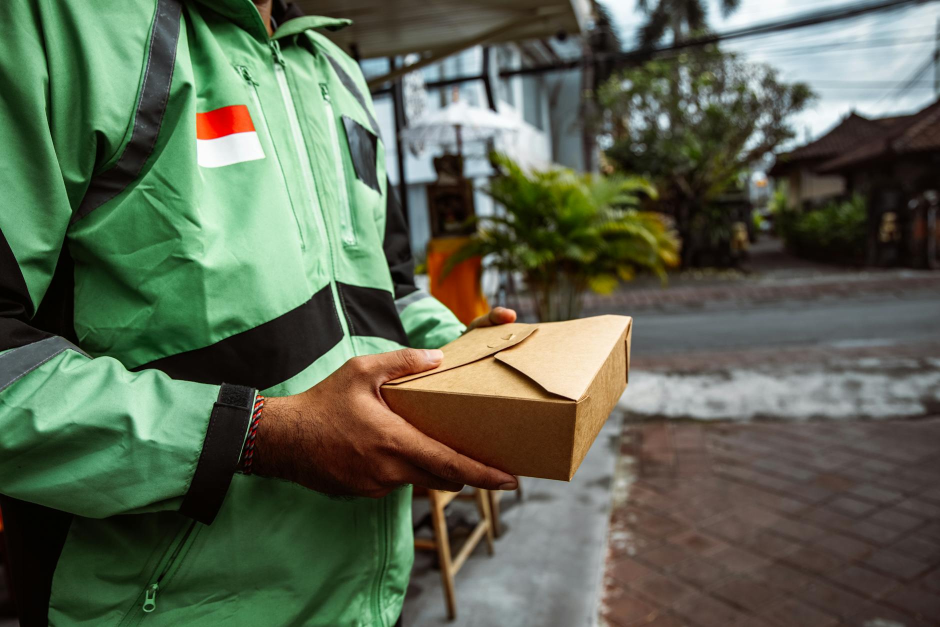 Food delivery person carrying insulated bags with restaurant orders for customer delivery
