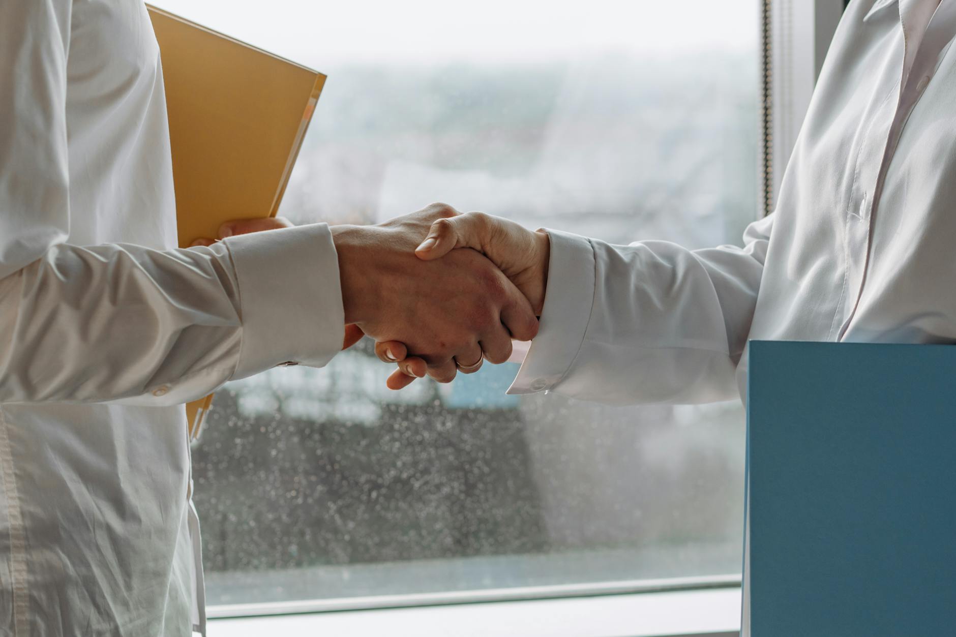 Business executives shaking hands over partnership agreement