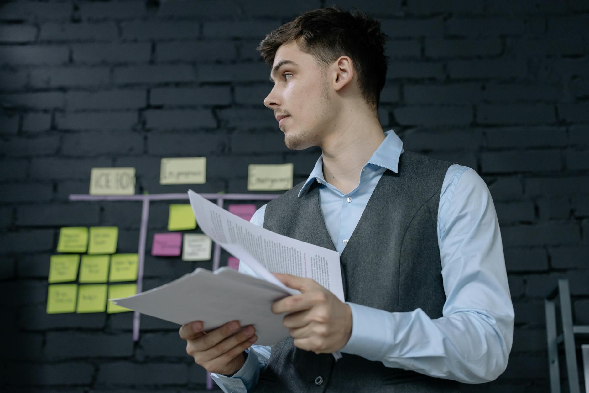 Young professional reviewing financial documents and investment portfolio at desk