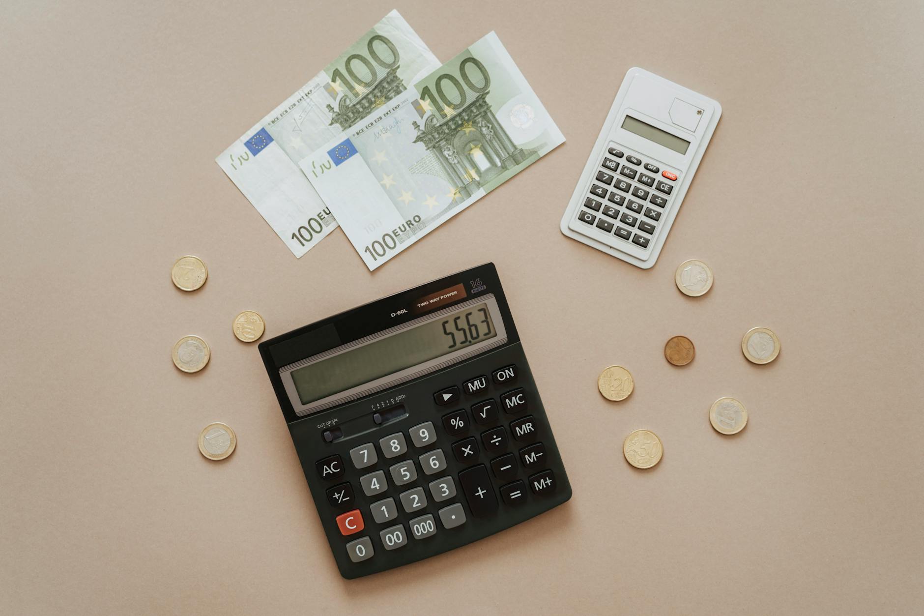 Financial calculator and money showing investment growth and dividend calculations