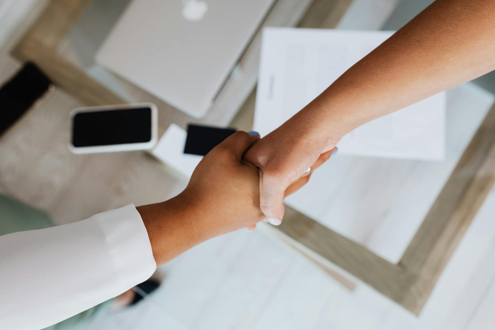 Professional business handshake representing wealth management and investment advisory services