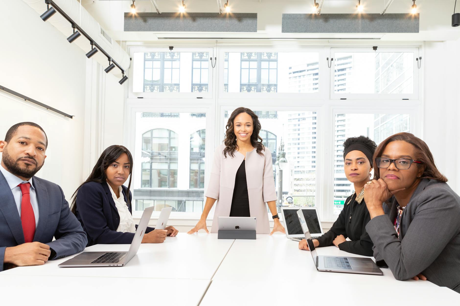 Professional business meeting with people discussing financial strategies around a conference table
