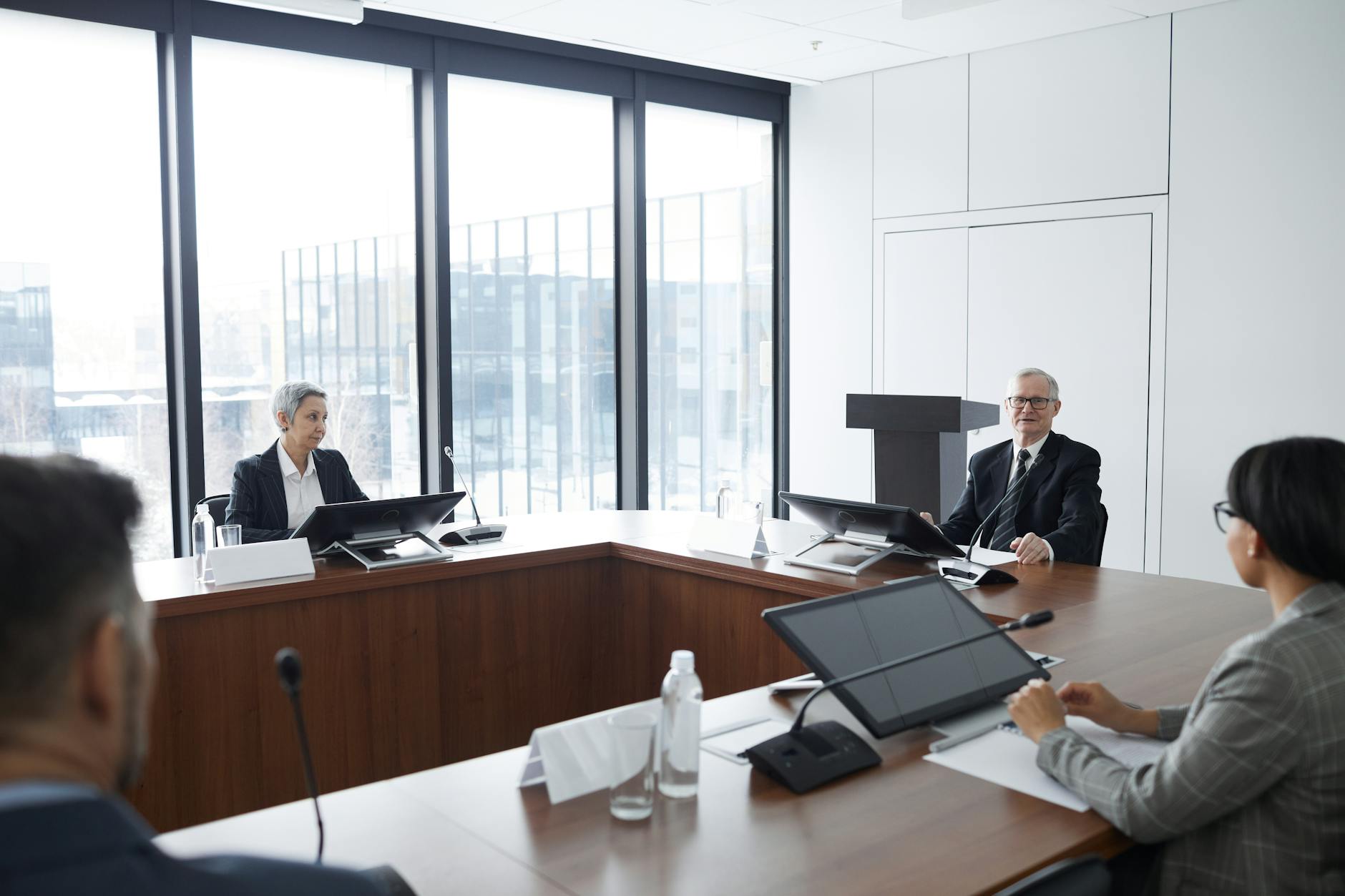 Professional business meeting with people discussing financial strategies around a conference table