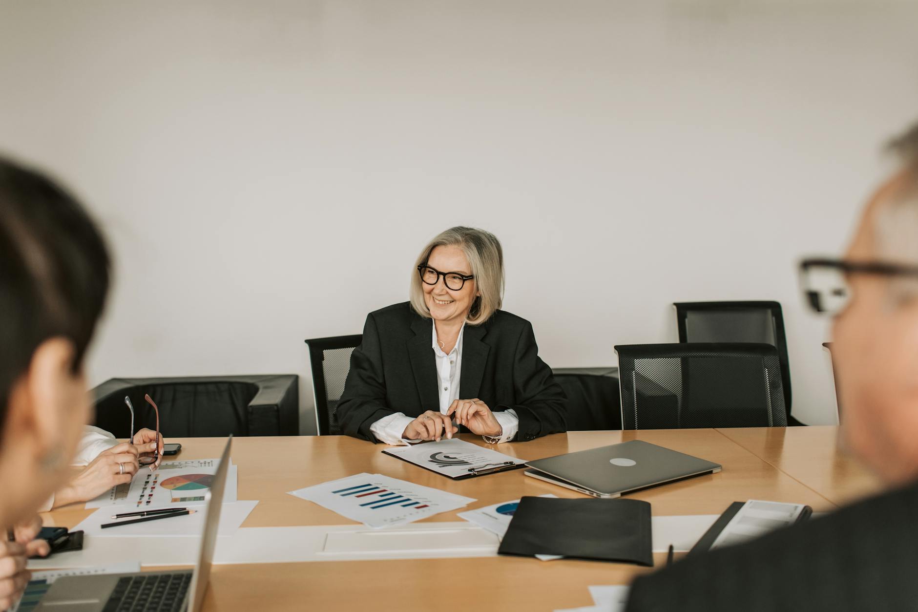 Corporate executives discussing strategy in modern conference room setting