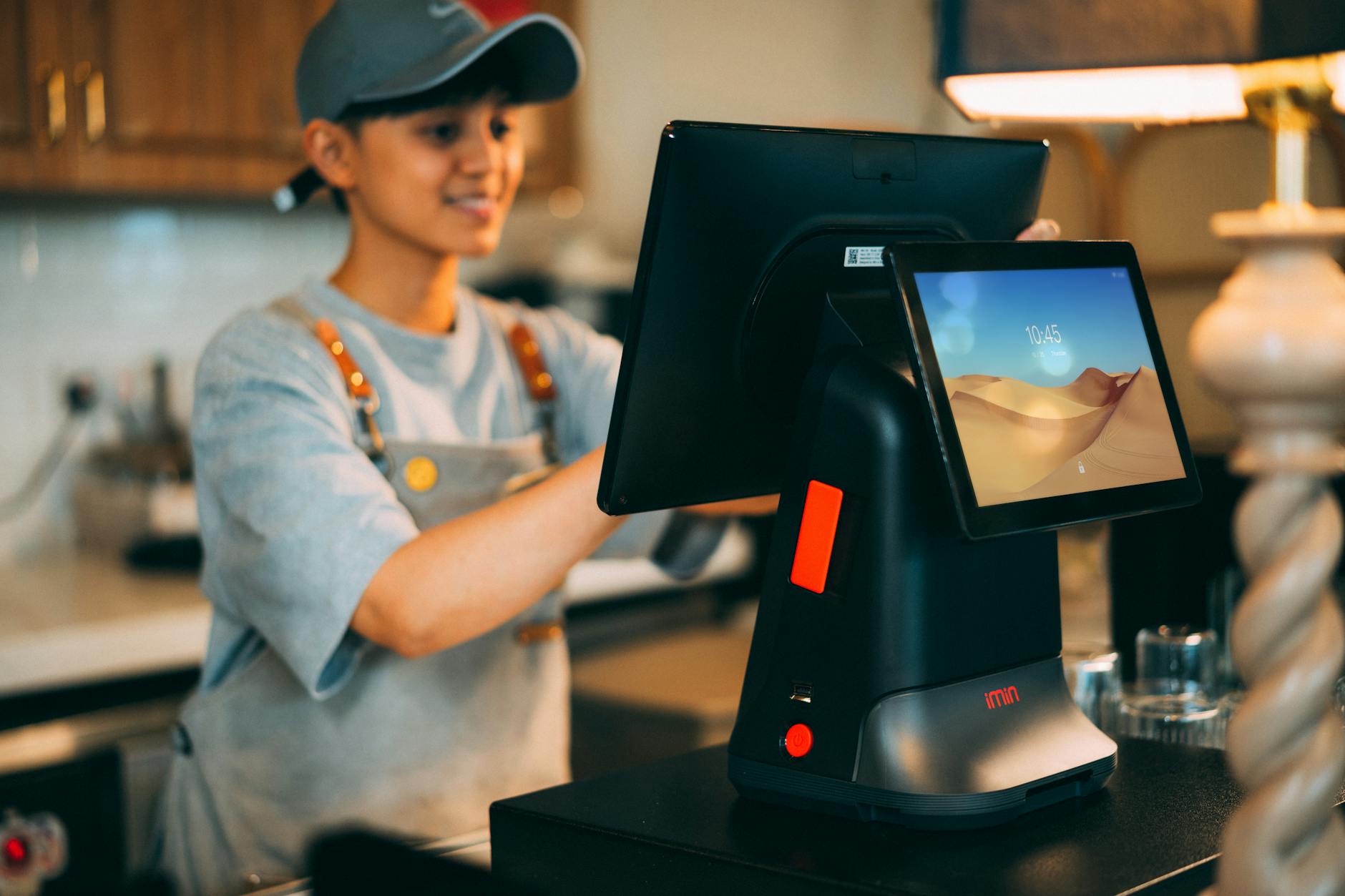 Professional cashier assisting customer at retail checkout counter