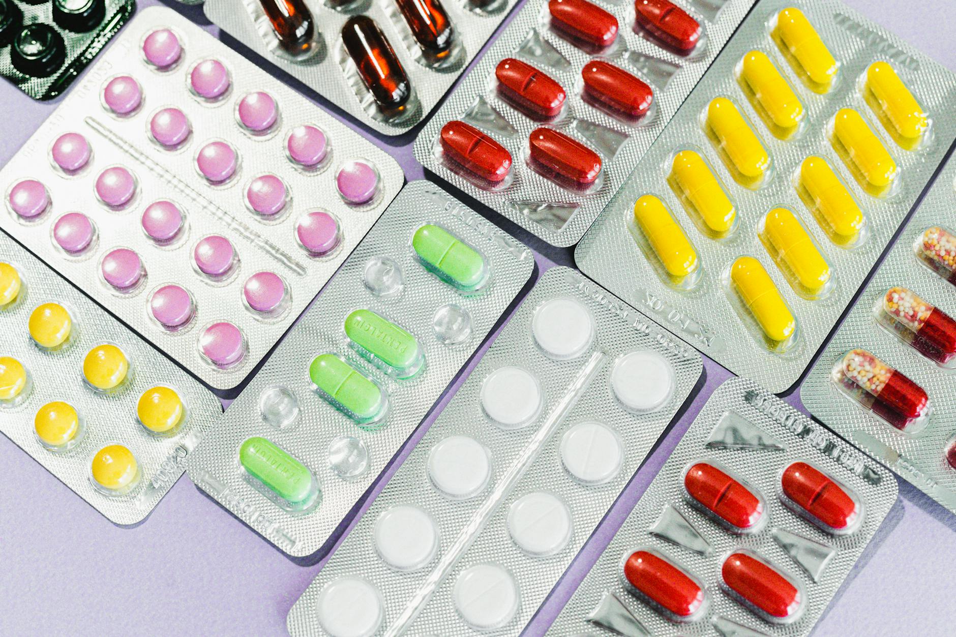 Pharmacist reviewing prescription medications at a pharmacy counter