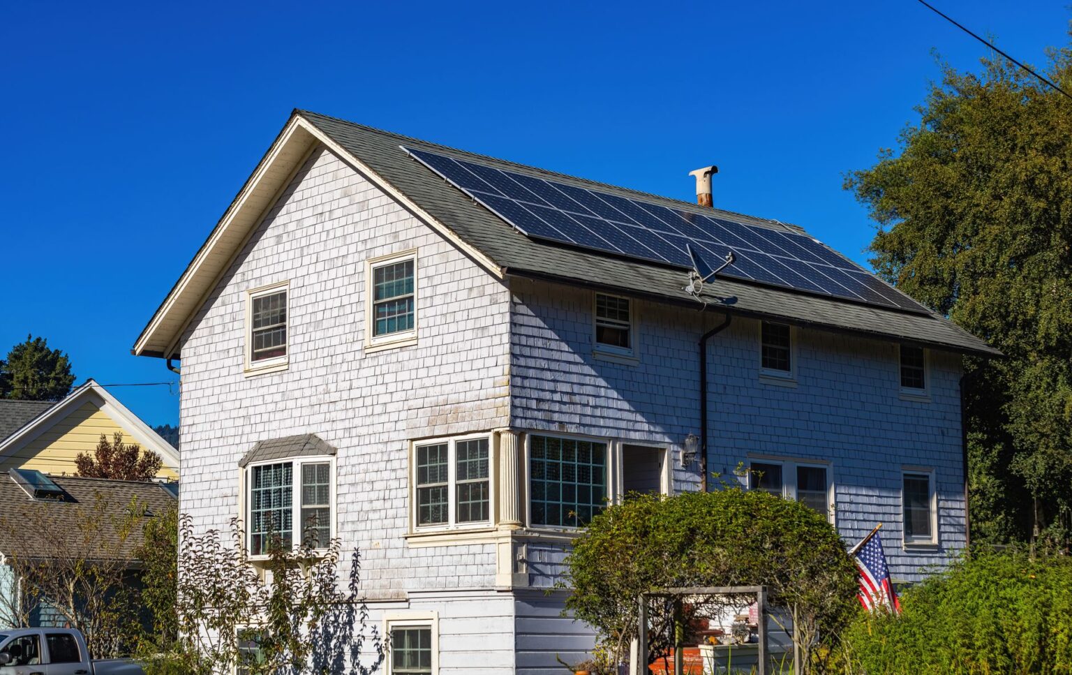 Solar panels installed on a residential rooftop in a suburban neighborhood