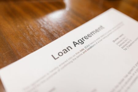 Person reviewing federal student loan documents at a desk