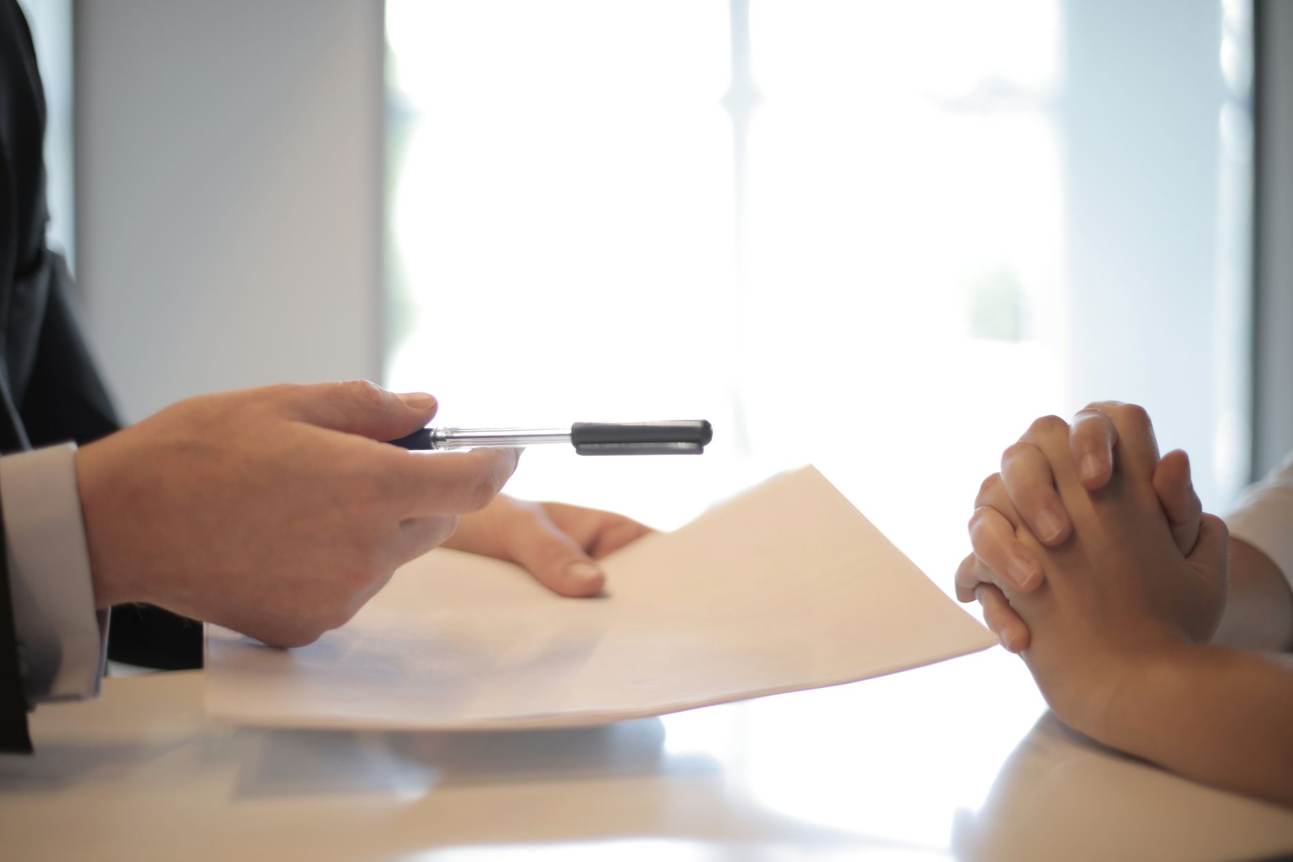 Loan application documents and pen on a desk at a bank