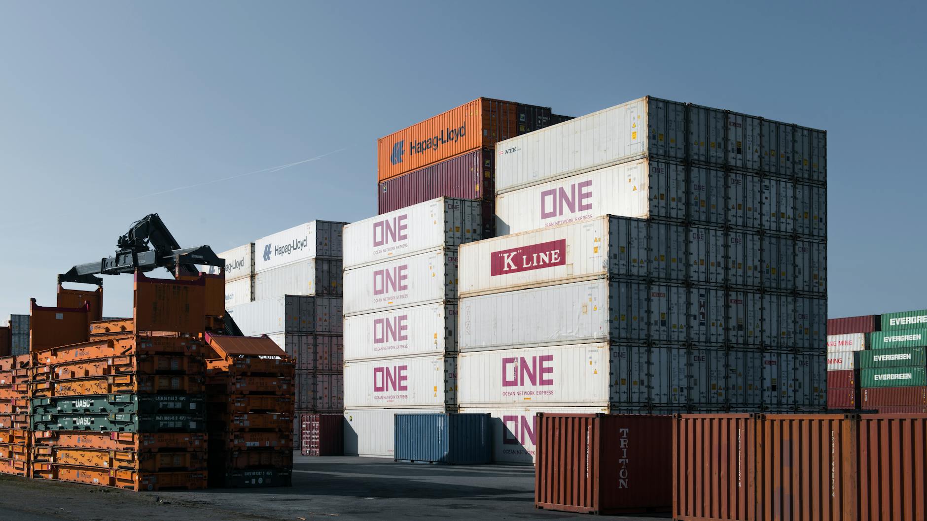 Rows of colorful shipping containers stacked at a marine terminal