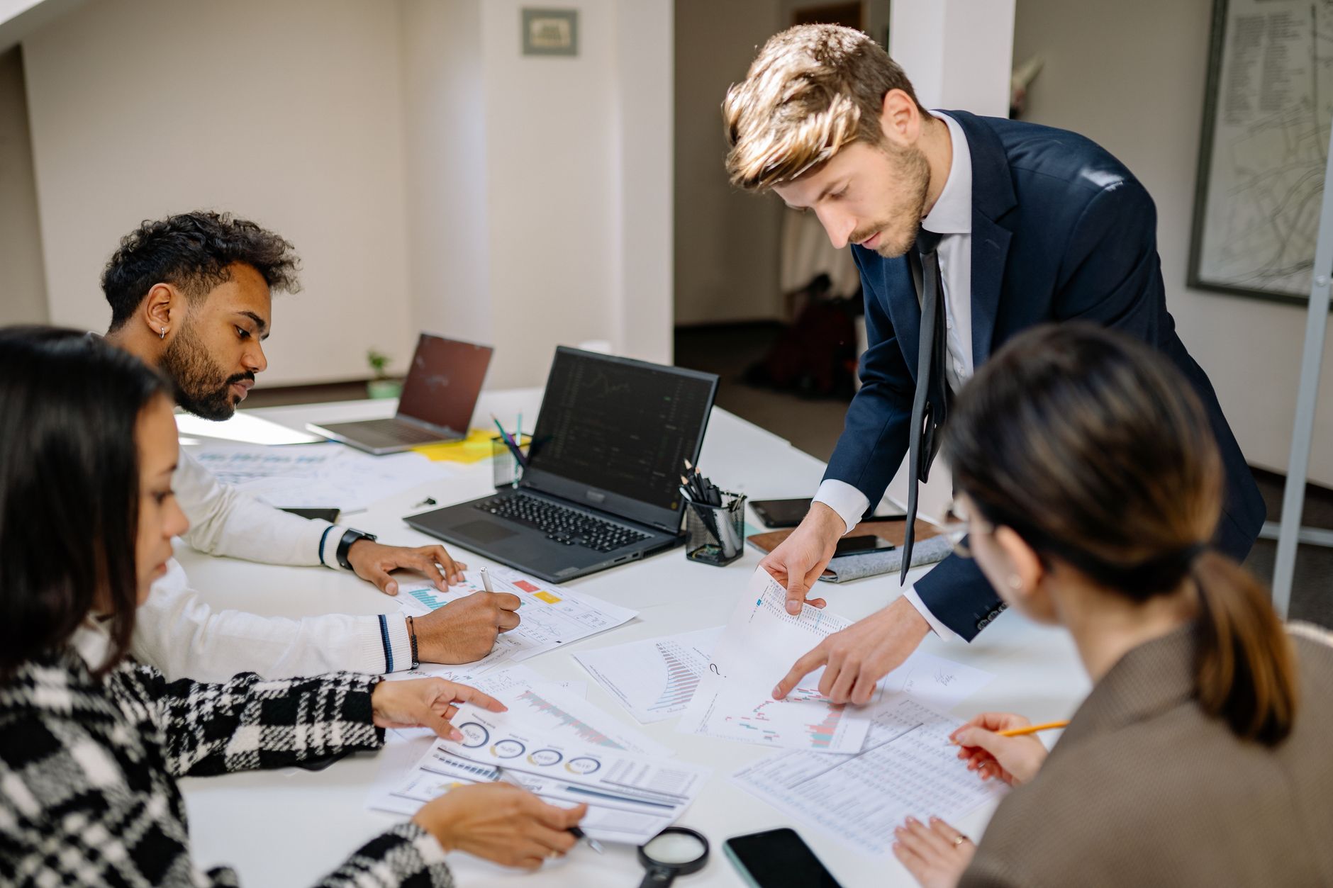 Business executives reviewing financial documents and budget plans at a conference table
