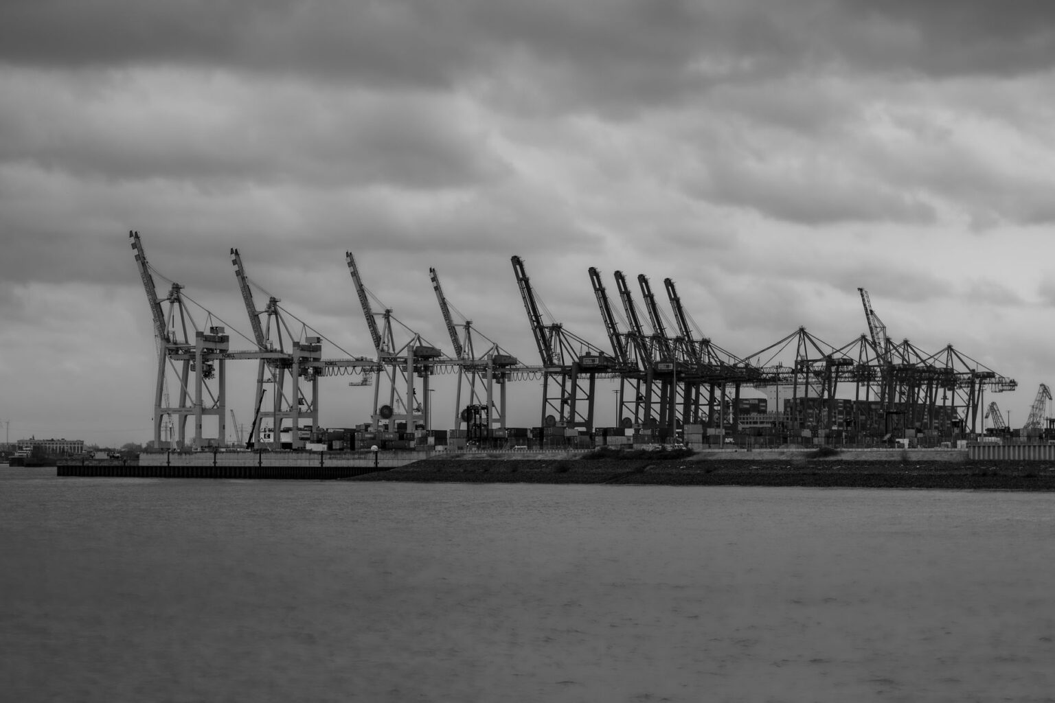 Large automated cranes operating at a commercial shipping port terminal