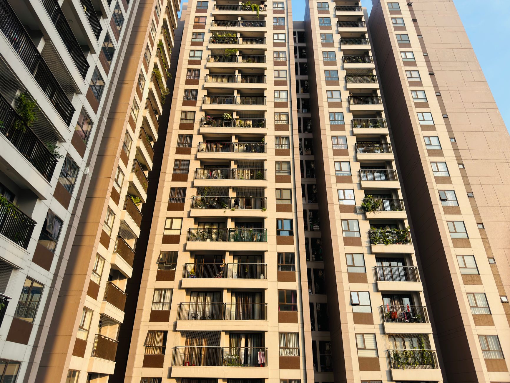Exterior view of a multi-story apartment building representing affordable housing challenges in urban areas
