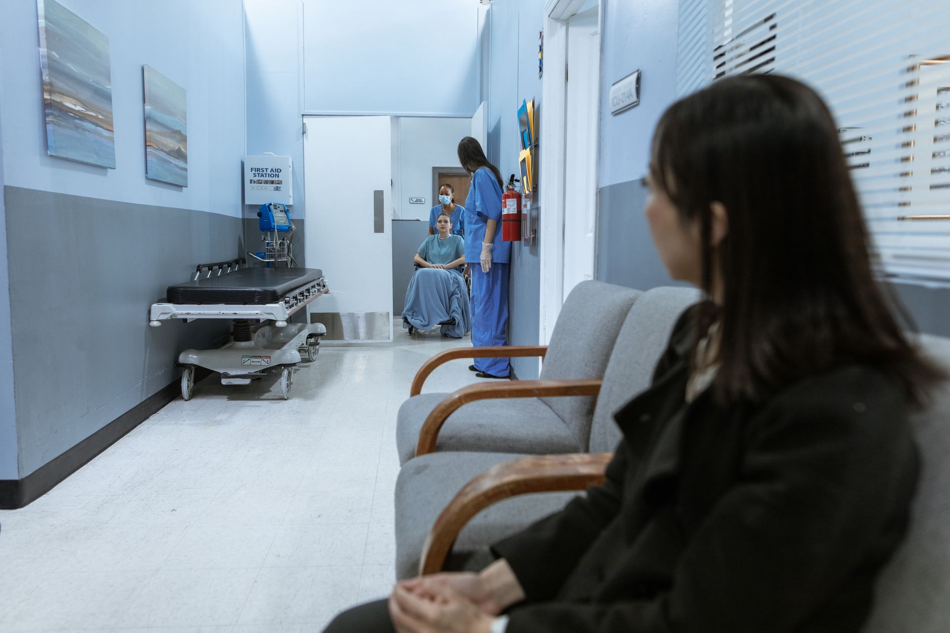 Patients sitting in a hospital waiting room, representing people affected by Medicaid coverage loss