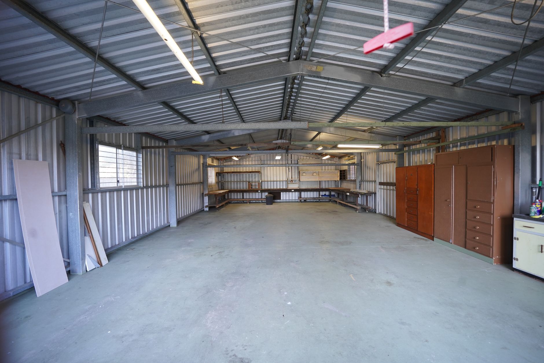 Large warehouse interior with stacked pallets and inventory on shelving systems